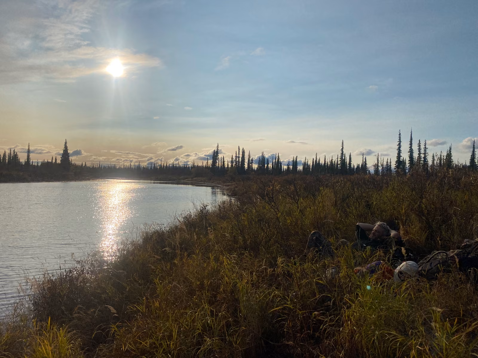 Low autumn sun over a quiet river bend near Huslia