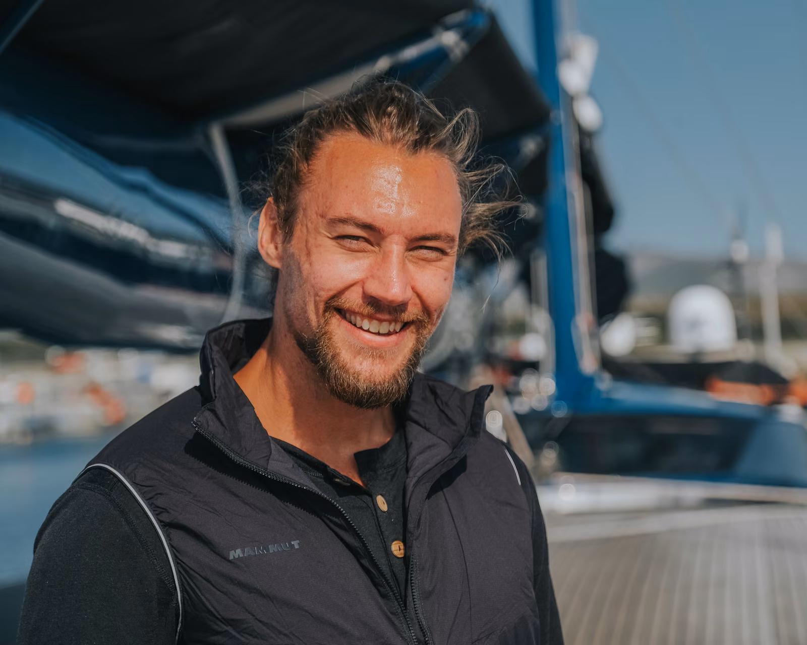 Stein Retzlaff, smiling, on the deck of a yacht