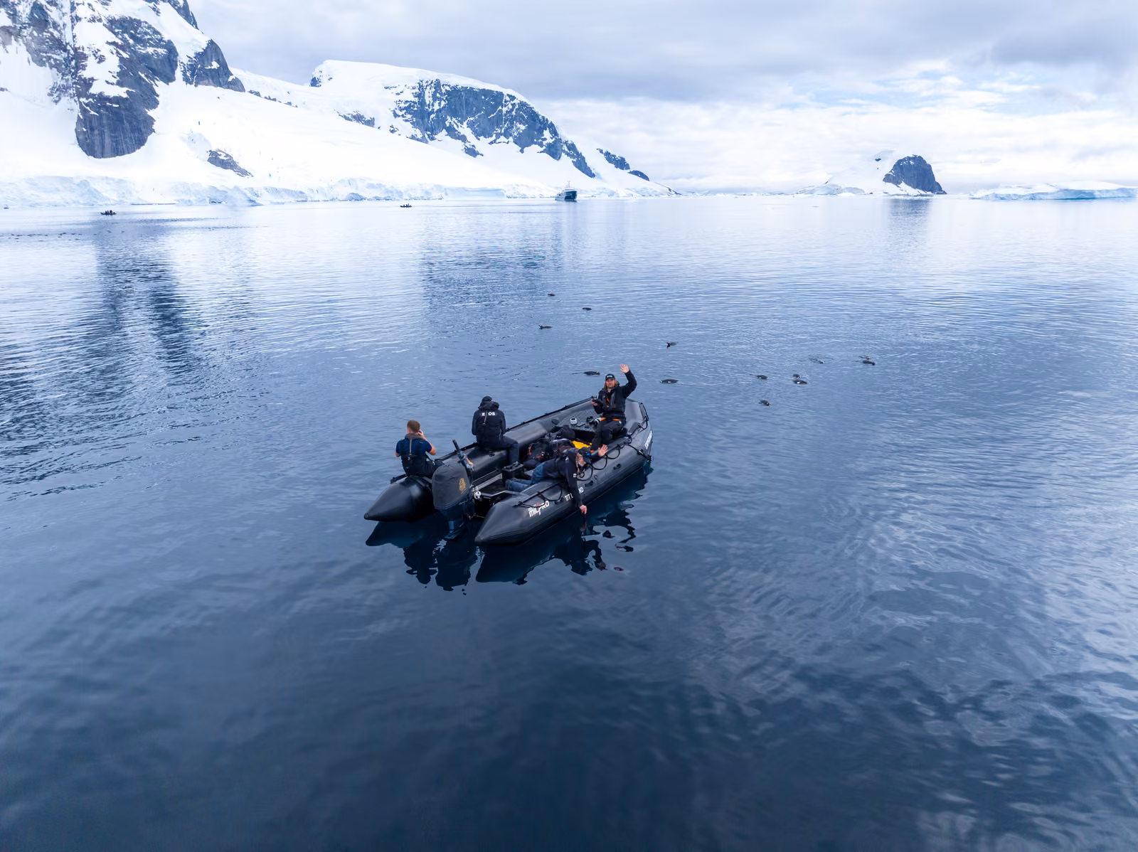A Zodiac crossing a mirror calm Antarctic channel
