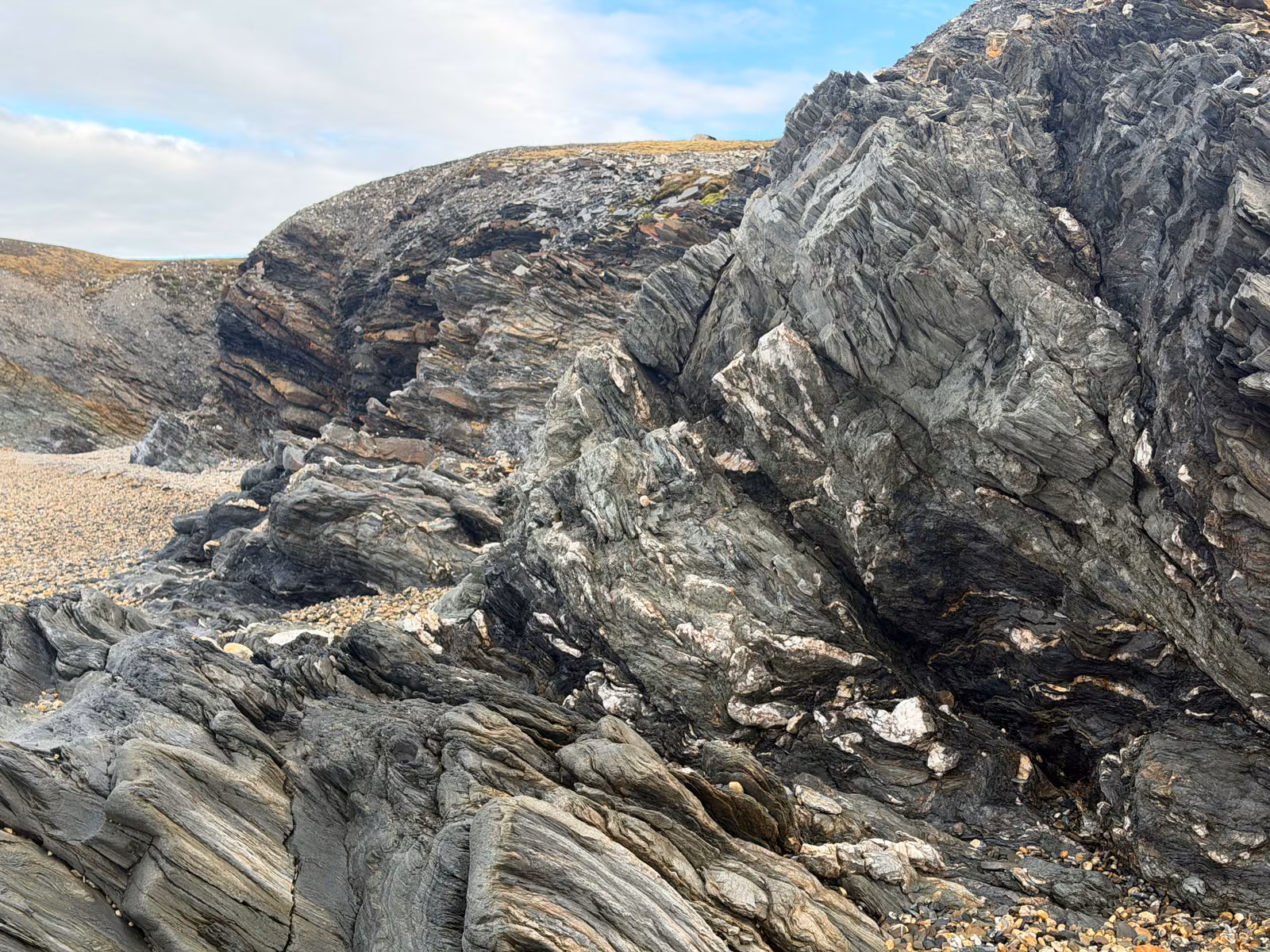 Folded banded rock on the shore of a Svalbard fjord