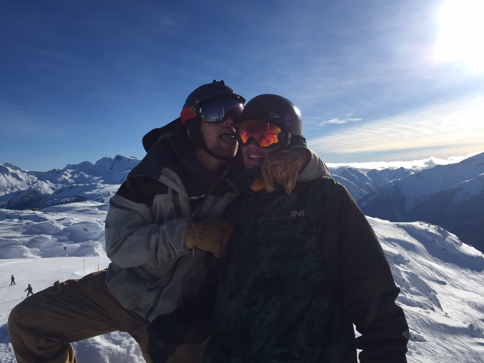 Two friends on a Whistler summit with the Coast Mountains behind